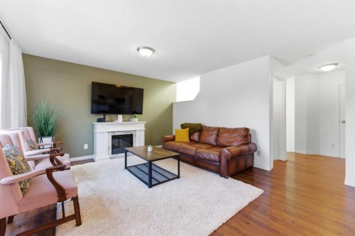 84 Mt Apex Green Se, Calgary, AB - Indoor Photo Showing Living Room With Fireplace
