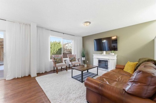 84 Mt Apex Green Se, Calgary, AB - Indoor Photo Showing Living Room With Fireplace