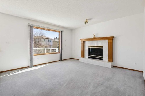 135 Sceptre Close Nw, Calgary, AB - Indoor Photo Showing Living Room With Fireplace