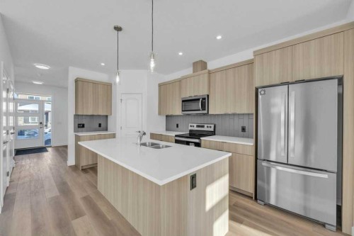 1115 Chinook Winds Circle Sw, Airdrie, AB - Indoor Photo Showing Kitchen With Stainless Steel Kitchen With Double Sink With Upgraded Kitchen