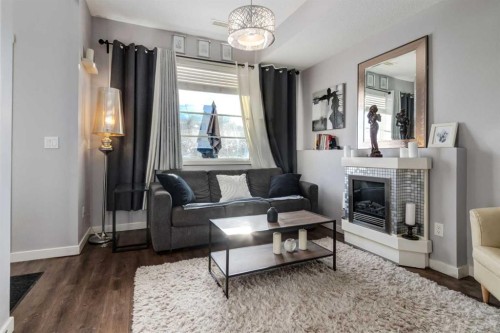 415 Saddlemont Boulevard Ne, Calgary, AB - Indoor Photo Showing Living Room With Fireplace