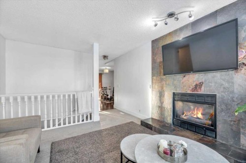 19 Castlepark Way Ne, Calgary, AB - Indoor Photo Showing Living Room With Fireplace