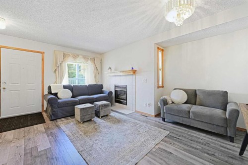 63 Anaheim Crescent Ne, Calgary, AB - Indoor Photo Showing Living Room With Fireplace