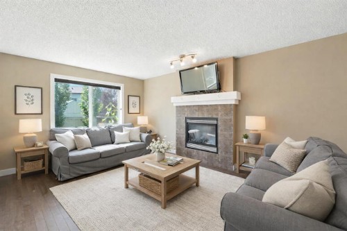 124 Kingsbridge Way Se, Airdrie, AB - Indoor Photo Showing Living Room With Fireplace