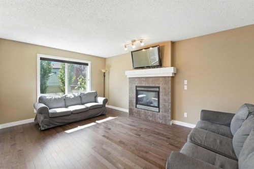 124 Kingsbridge Way Se, Airdrie, AB - Indoor Photo Showing Living Room With Fireplace