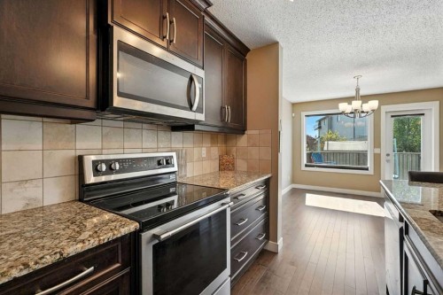 124 Kingsbridge Way Se, Airdrie, AB - Indoor Photo Showing Kitchen With Stainless Steel Kitchen With Double Sink With Upgraded Kitchen
