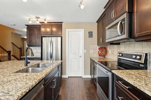 124 Kingsbridge Way Se, Airdrie, AB - Indoor Photo Showing Kitchen With Stainless Steel Kitchen With Double Sink With Upgraded Kitchen