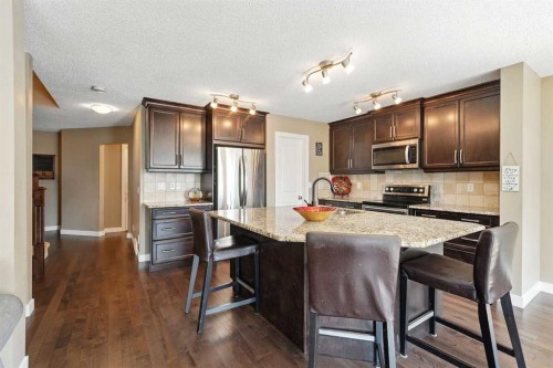 124 Kingsbridge Way Se, Airdrie, AB - Indoor Photo Showing Kitchen With Stainless Steel Kitchen With Upgraded Kitchen