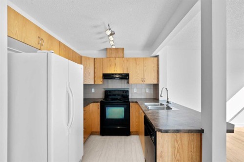 85 Panatella Villas Nw, Calgary, AB - Indoor Photo Showing Kitchen With Double Sink