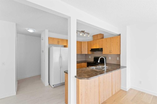 85 Panatella Villas Nw, Calgary, AB - Indoor Photo Showing Kitchen With Double Sink