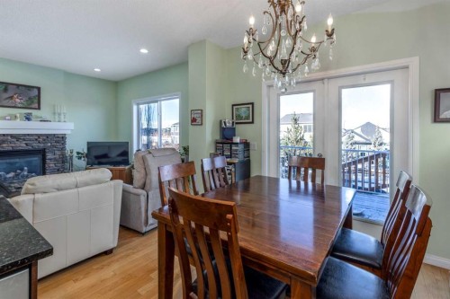 158 Fireside Bend, Cochrane, AB - Indoor Photo Showing Dining Room With Fireplace