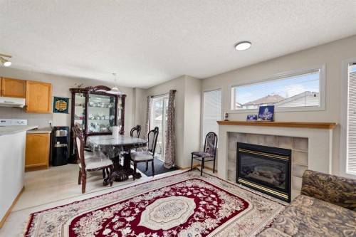 101 Taravista Crescent, Calgary, AB - Indoor Photo Showing Living Room With Fireplace
