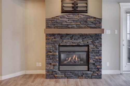 209-10 Discovery Ridge Close Sw, Calgary, AB - Indoor Photo Showing Living Room With Fireplace