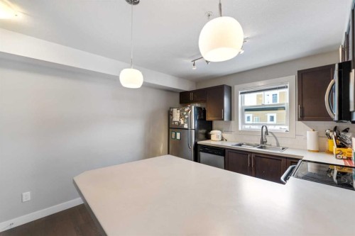 201-2300 Evanston Square Nw, Calgary, AB - Indoor Photo Showing Kitchen With Double Sink