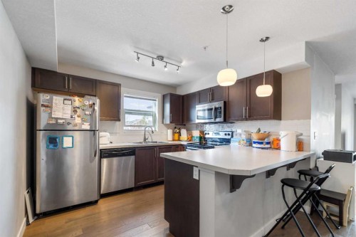201-2300 Evanston Square Nw, Calgary, AB - Indoor Photo Showing Kitchen With Upgraded Kitchen