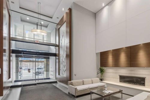 521-222 Riverfront Avenue Sw, Calgary, AB - Indoor Photo Showing Other Room With Fireplace