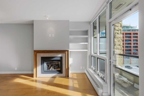 521-222 Riverfront Avenue Sw, Calgary, AB - Indoor Photo Showing Living Room With Fireplace