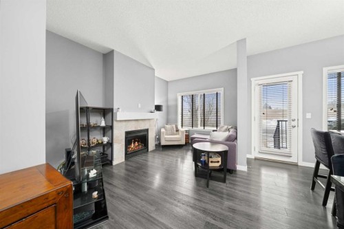 15 Copperpond Landing Se, Calgary, AB - Indoor Photo Showing Living Room With Fireplace