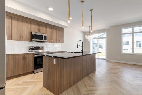 349 Heartwood Park Se, Calgary, AB - Indoor Photo Showing Kitchen With Upgraded Kitchen