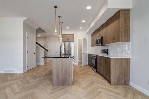 349 Heartwood Park Se, Calgary, AB - Indoor Photo Showing Kitchen With Upgraded Kitchen