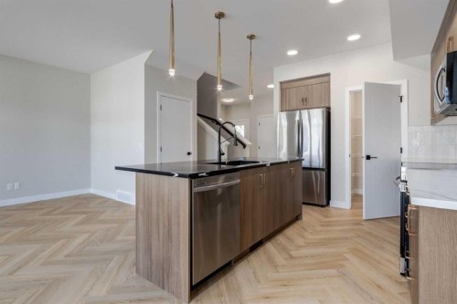 349 Heartwood Park Se, Calgary, AB - Indoor Photo Showing Kitchen With Upgraded Kitchen
