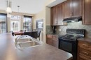 93 Copperleaf Way Se, Calgary, AB  - Indoor Photo Showing Kitchen With Double Sink 
