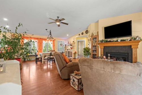115 Dunham Lane, Diamond Valley, AB - Indoor Photo Showing Living Room With Fireplace