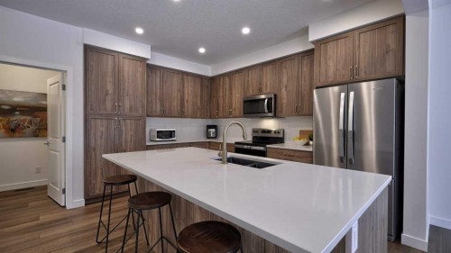 57 Willow Green Sw, Airdrie, AB - Indoor Photo Showing Kitchen With Double Sink With Upgraded Kitchen