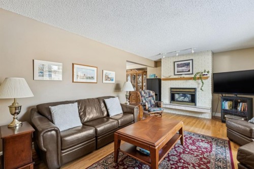 3347 Upton Place Nw, Calgary, AB - Indoor Photo Showing Living Room With Fireplace