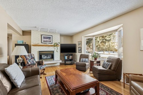 3347 Upton Place Nw, Calgary, AB - Indoor Photo Showing Living Room With Fireplace