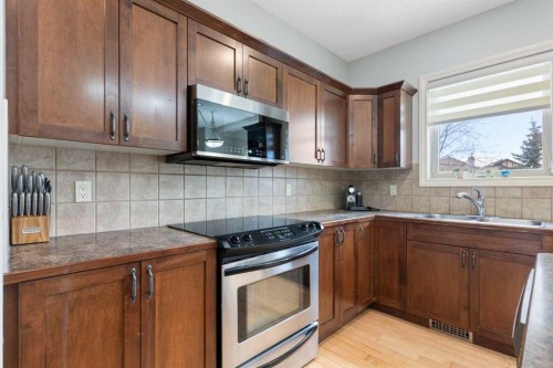 52 Glensummit Close, Cochrane, AB - Indoor Photo Showing Kitchen With Double Sink