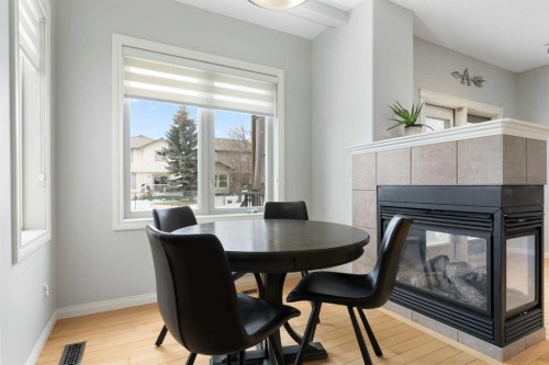 52 Glensummit Close, Cochrane, AB - Indoor Photo Showing Dining Room With Fireplace