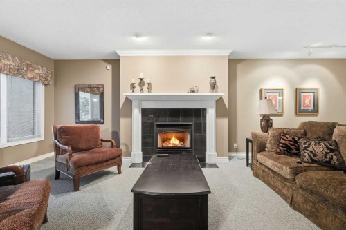 23 Prominence Point Sw, Calgary, AB - Indoor Photo Showing Living Room With Fireplace
