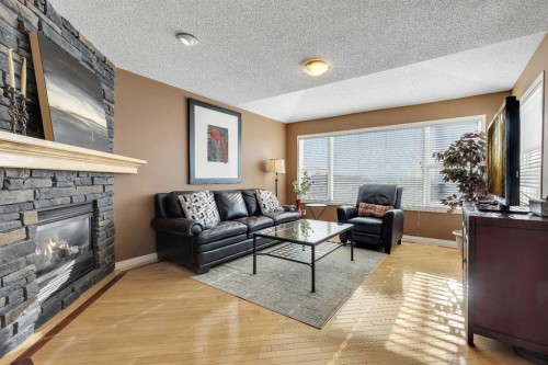 133 Rocky Ridge Heath Nw, Calgary, AB - Indoor Photo Showing Living Room With Fireplace