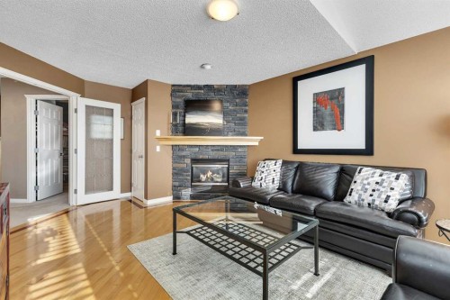 133 Rocky Ridge Heath Nw, Calgary, AB - Indoor Photo Showing Living Room With Fireplace