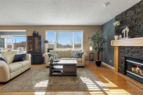 133 Rocky Ridge Heath Nw, Calgary, AB - Indoor Photo Showing Living Room With Fireplace
