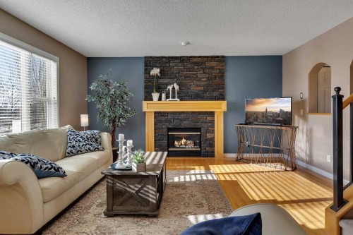 133 Rocky Ridge Heath Nw, Calgary, AB - Indoor Photo Showing Living Room With Fireplace
