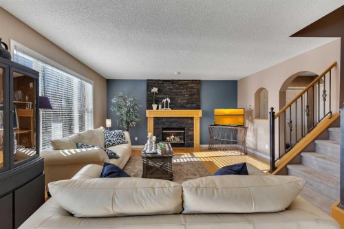 133 Rocky Ridge Heath Nw, Calgary, AB - Indoor Photo Showing Living Room With Fireplace
