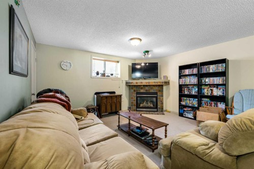 172 Prestwick Heights Se, Calgary, AB - Indoor Photo Showing Living Room With Fireplace