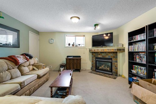 172 Prestwick Heights Se, Calgary, AB - Indoor Photo Showing Living Room With Fireplace