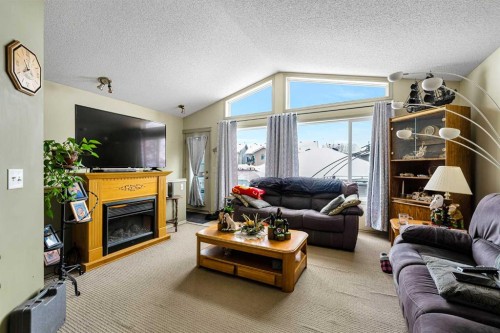 172 Prestwick Heights Se, Calgary, AB - Indoor Photo Showing Living Room With Fireplace