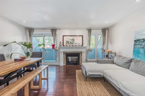8-834 2 Avenue Nw, Calgary, AB - Indoor Photo Showing Living Room With Fireplace