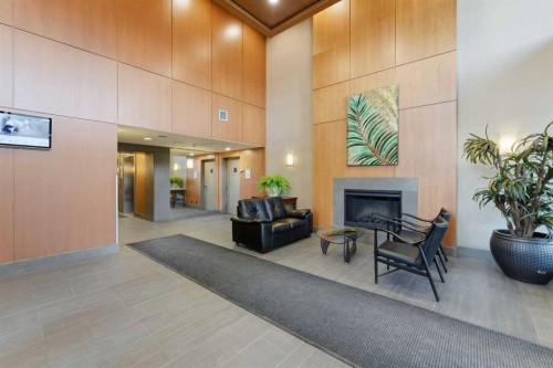 702-77 Spruce Place Sw, Calgary, AB - Indoor Photo Showing Other Room With Fireplace