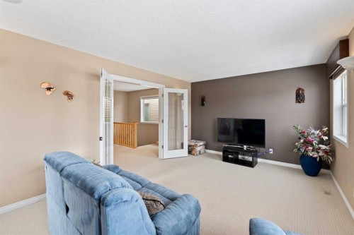 43 Cougarstone Court Sw, Calgary, AB - Indoor Photo Showing Living Room