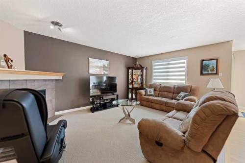 43 Cougarstone Court Sw, Calgary, AB - Indoor Photo Showing Living Room With Fireplace
