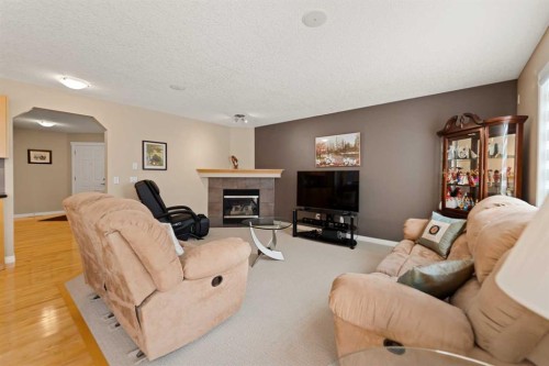 43 Cougarstone Court Sw, Calgary, AB - Indoor Photo Showing Living Room With Fireplace