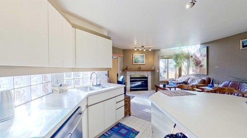 2219 Westmount Road Nw, Calgary, AB - Indoor Photo Showing Kitchen With Fireplace