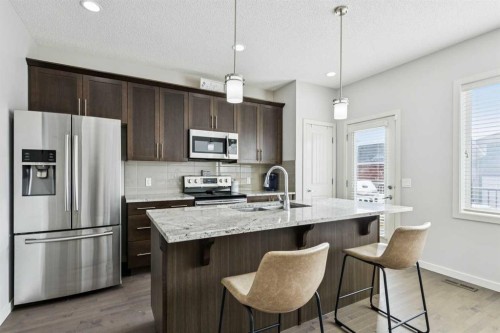 50 Fireside Circle, Cochrane, AB - Indoor Photo Showing Kitchen With Double Sink With Upgraded Kitchen