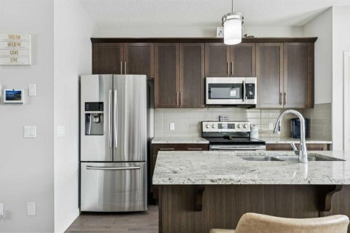 50 Fireside Circle, Cochrane, AB - Indoor Photo Showing Kitchen With Double Sink With Upgraded Kitchen