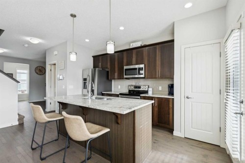 50 Fireside Circle, Cochrane, AB - Indoor Photo Showing Kitchen With Double Sink With Upgraded Kitchen